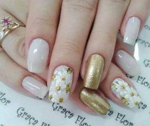 unhas decoradas com flores douradas